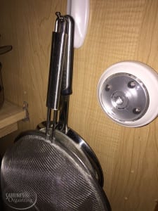 hand strainers using hooks in cabinets