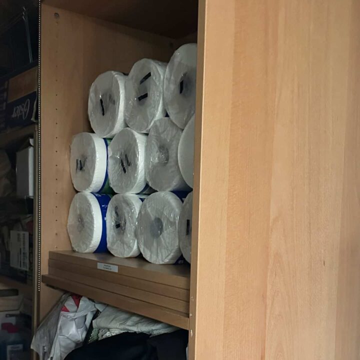 cabinet with toilet paper rolls in it