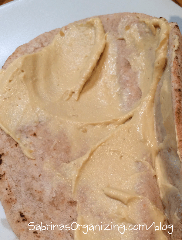 spread the hummus on the pita bread