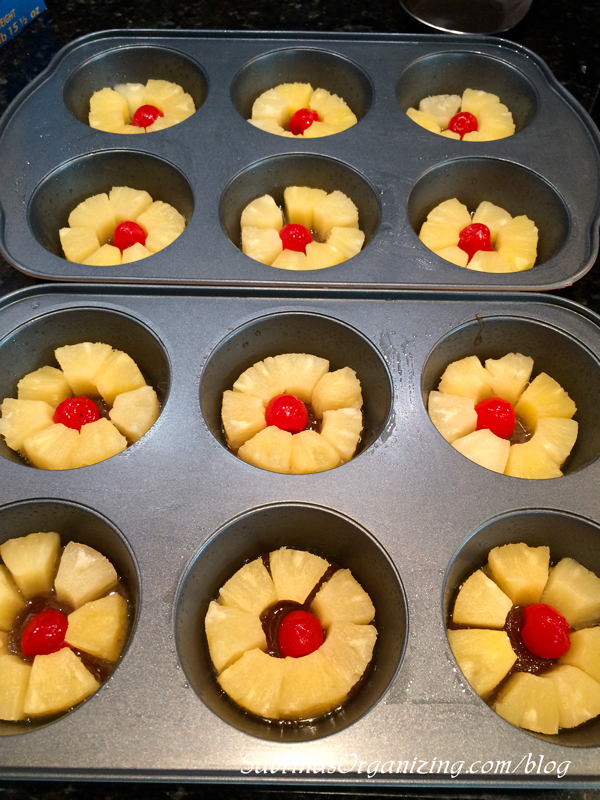 place the pineapple and 1 hole cherry in each larger muffin tin