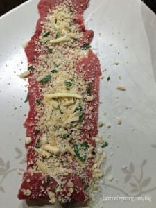 place the thin meat on the plate and then sprinkle the mixture on it and roll it up