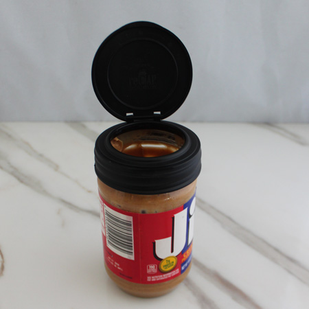 MasonJars.com 2 inch lids works great with the 16 oz peanut butter jar