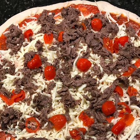 uncooked cheesesteak pizza pie