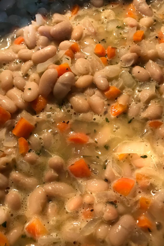 add broth to beans mixture