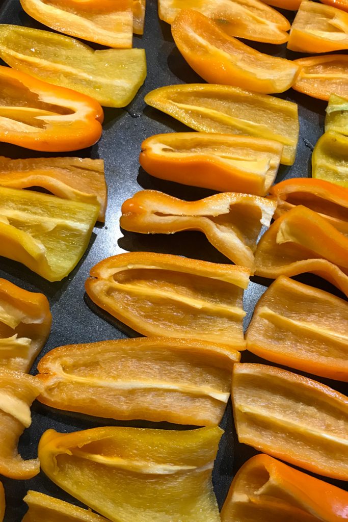 cut the peppers and remove the seeds and place on a baking sheet. 
