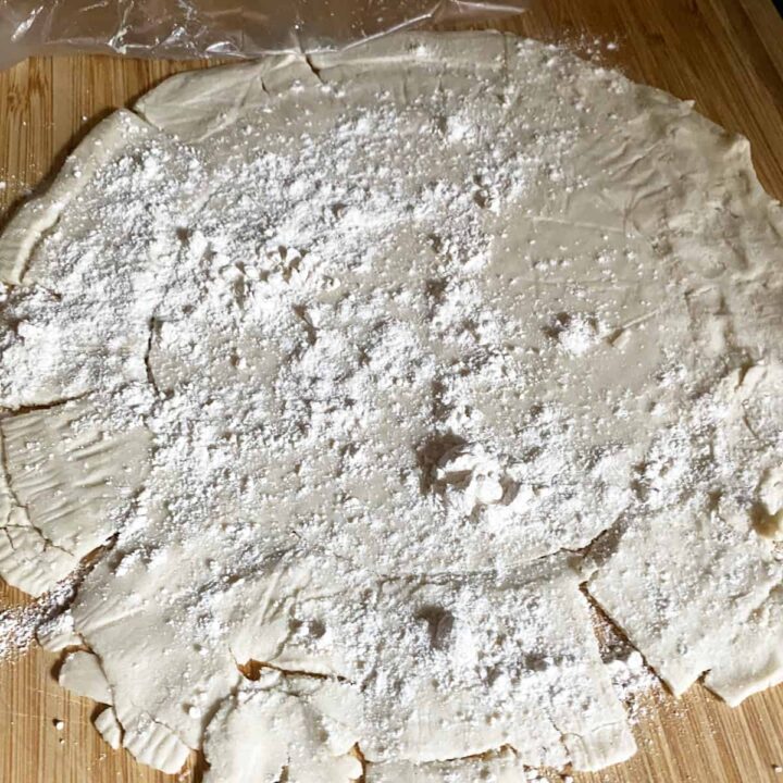 Pressed the defrosted floured gluten free pie crust on cutting board - square image