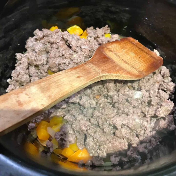 Add cooked ground beef and other ingredients to the slow cooker