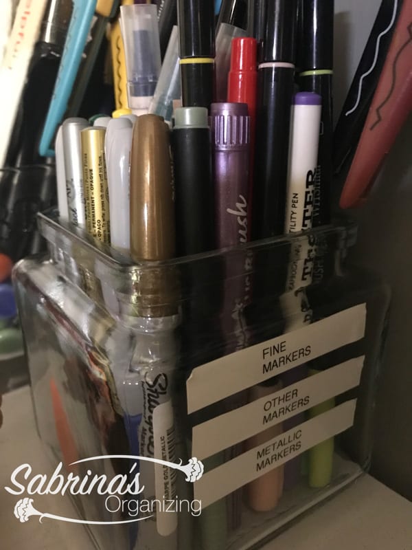 Keep pens upright in a labeled container