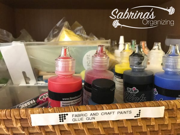 Organizing fabric paints with an organizer inside a wicker serving tray