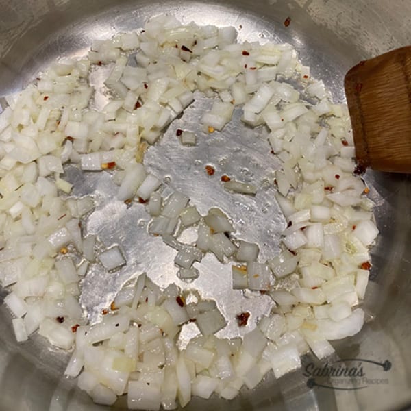 Onion and red pepper flakes in the saucepan