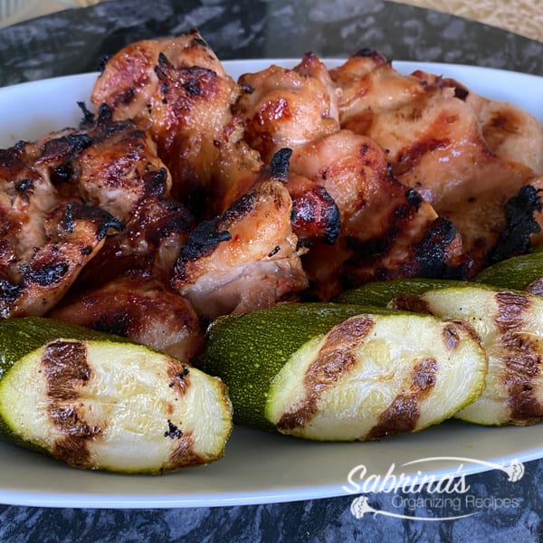 Grilled Asian Chicken Thighs Recipe on a plate with zucchini