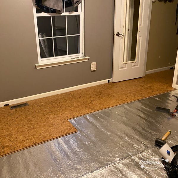How to Transform a Bedroom from Carpet to Cork Flooring the start of installing cork flooring over underlayment