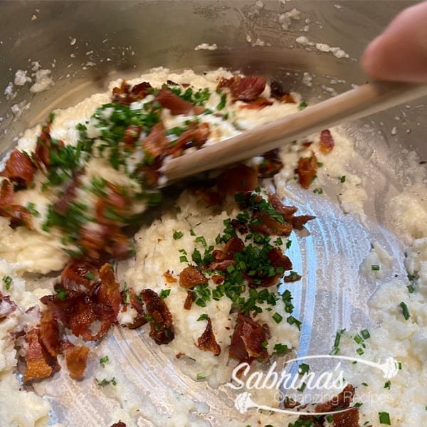 stirring bacon into the mashed turnips