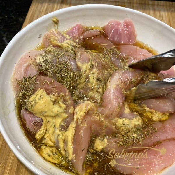 Chicken Breast and herbs mixed in bowl