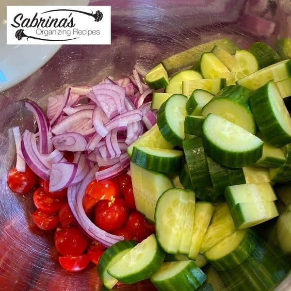 Add the tomatoes, cucumbers, and onions to a bowl