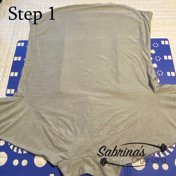 Step one of folding a workout shirt