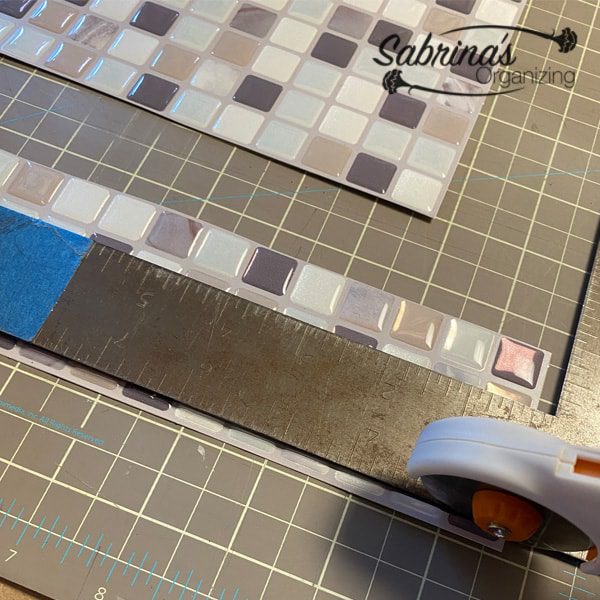 Using a cutter cut the excess tile off