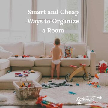 Messy living room with a baby standing near a sofa with toys everywhere - title over lay at the top center