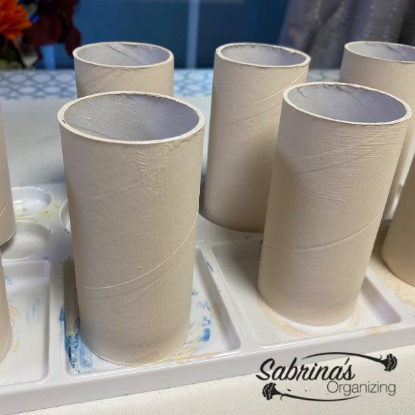 Paint all eight toilet paper rolls