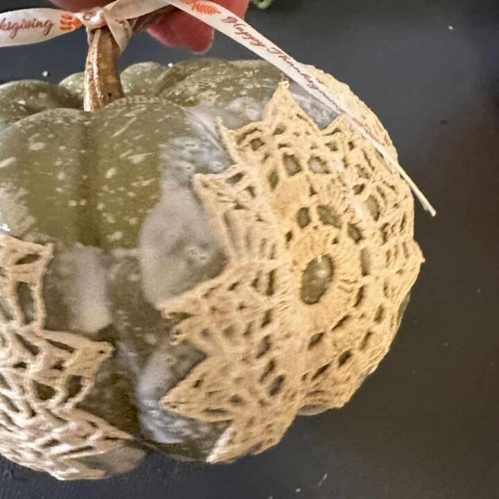 Adding ribbon to the top step of the green pumpkin