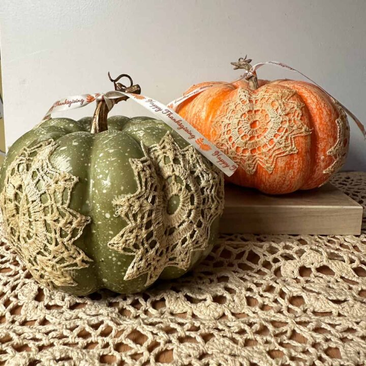 square image - final picture - green and orange pumpkins over a piece of crochet lace placemat