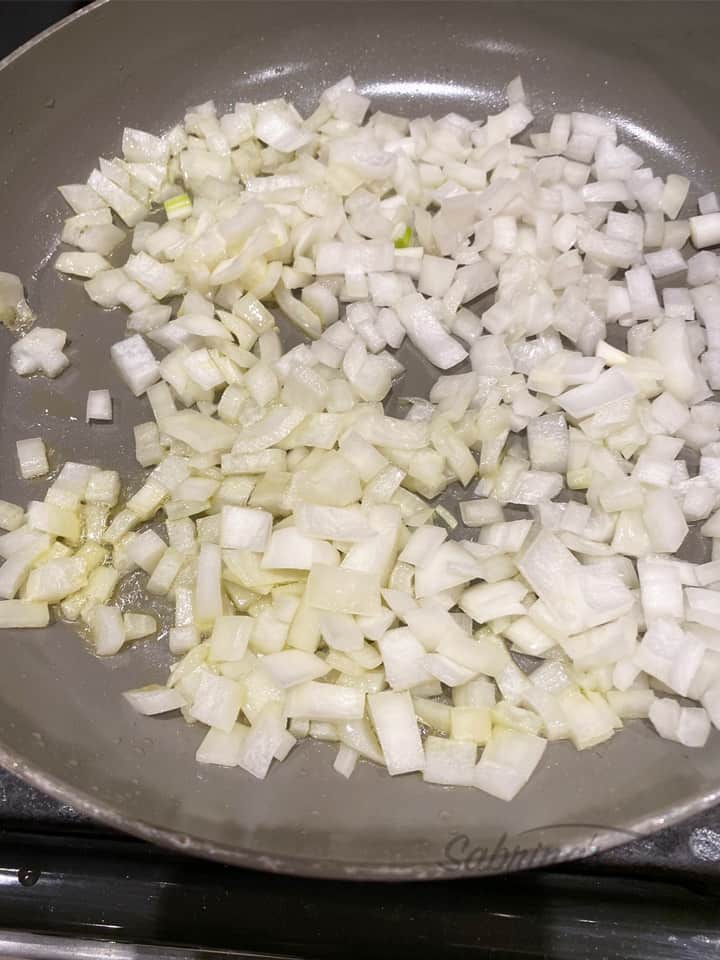 chopped onion cooking in a skillet by sabrinasorganizing