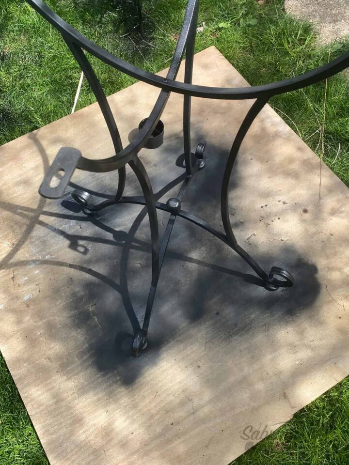 Use Spray Paint in Black and spray the legs of the bistro table