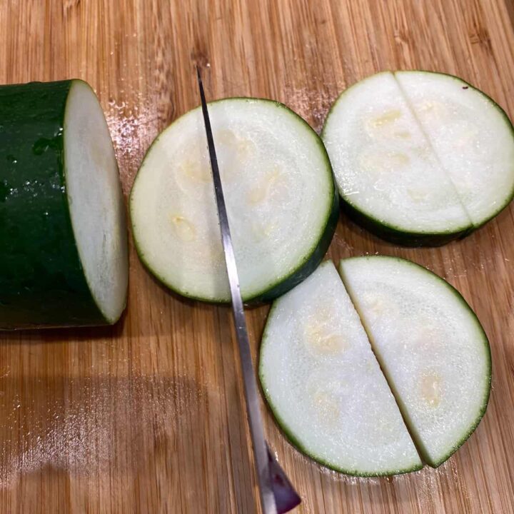 Slice zucchini in half inch slices then half moon