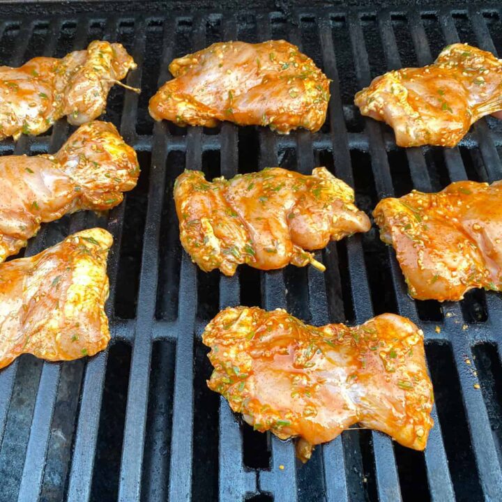 raw chicken on the grill - square image