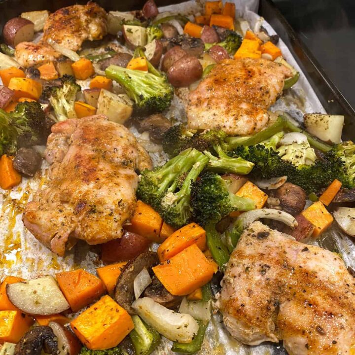 Chicken Thigh Sheet Pan Recipe with Broccoli Sweet Potato and Bell Pepper cooked on a baking sheet
