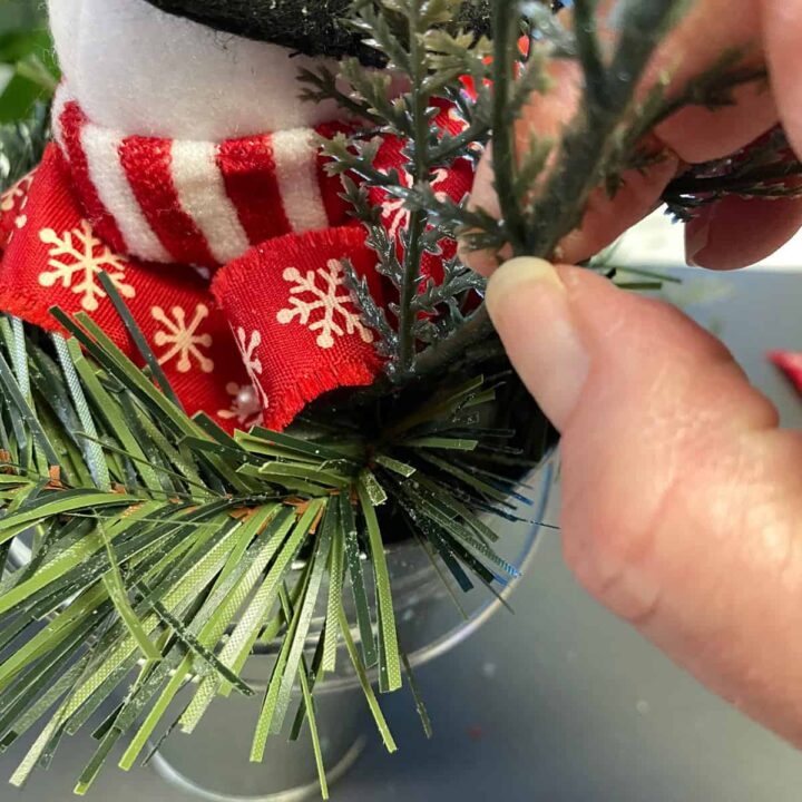 Add the snowman and faux leaves to foam