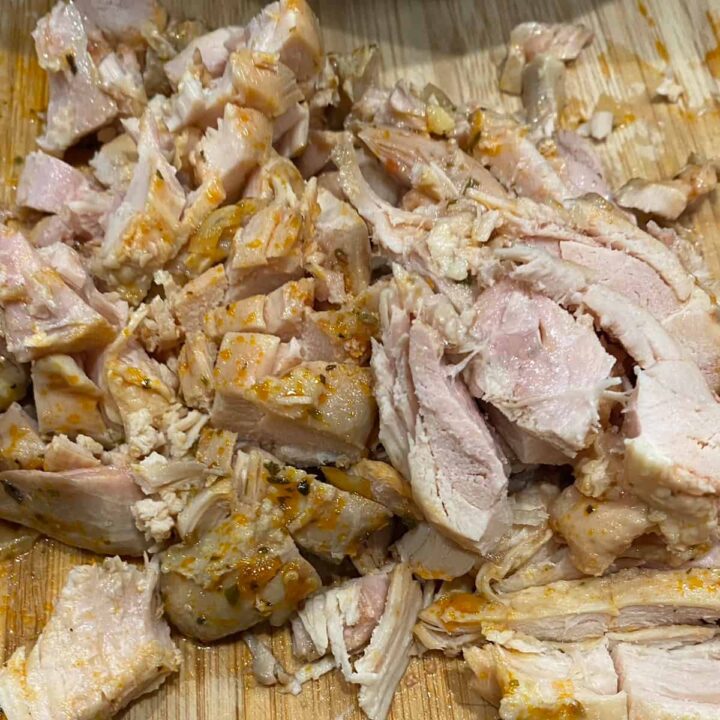 Chop up the cooked chicken thighs