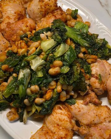 Chicken Thighs with White Beans and Escarole on platter - featured image
