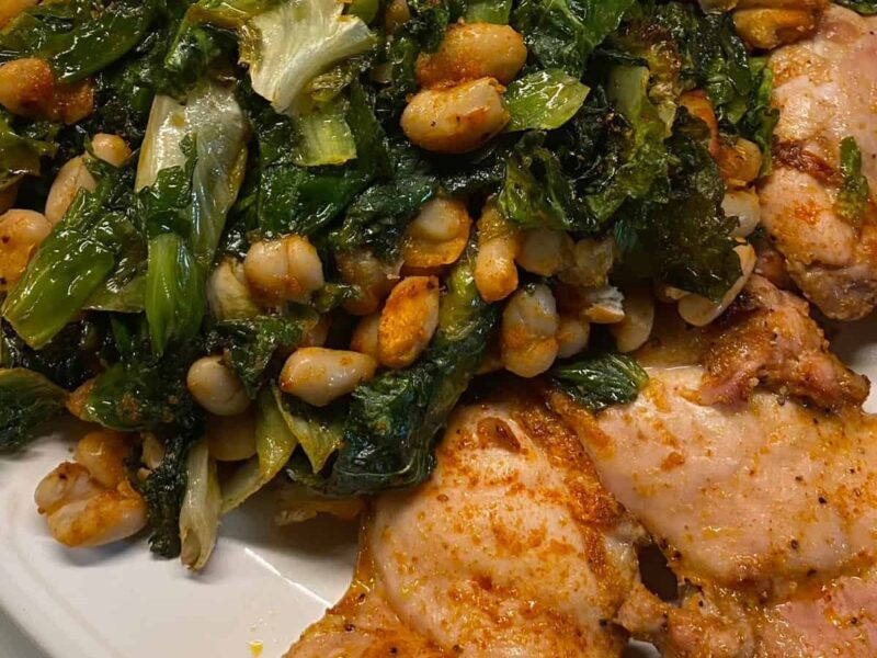 Chicken Thighs with White Beans and Escarole on platter - square image