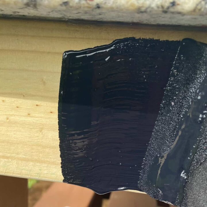 Paint the pressure treated wood black stain.