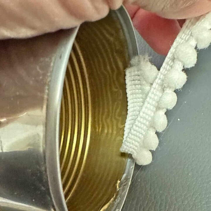 Using glue add ribbon around the inside of the can