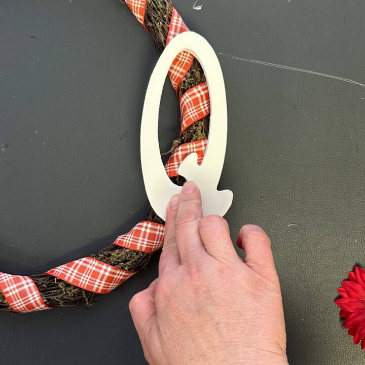 Adhere the Q to the wreath side with hot glue