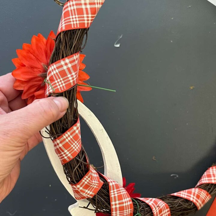 Wrap the wire from the back of the flower to the wreath