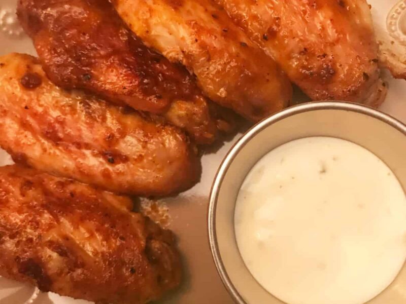 Buffalo Chicken Wings on a plate with celery and blue cheese dip