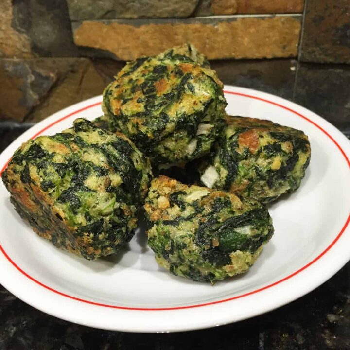 cooked spinach balls on a plate square image