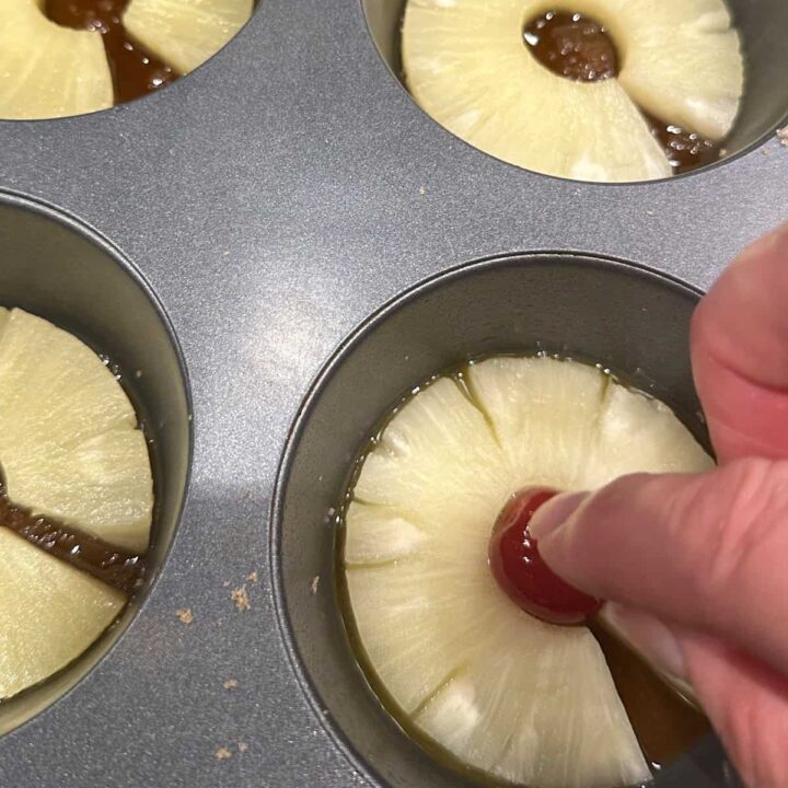 Add the cherries to the muffin tin