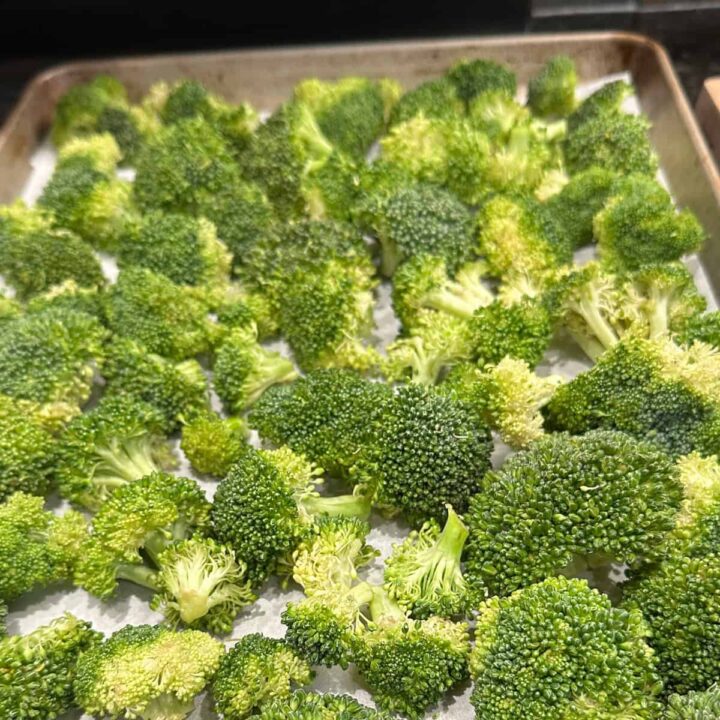 Add broccoli to the parchment paper on the baking sheet