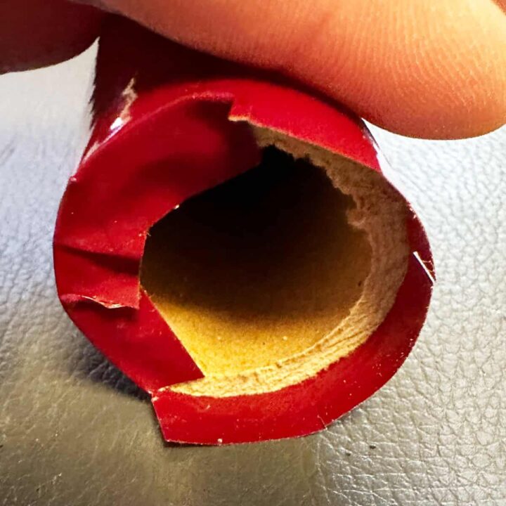 cut slits in the excess vinyl at the top and fold into the center of tube.