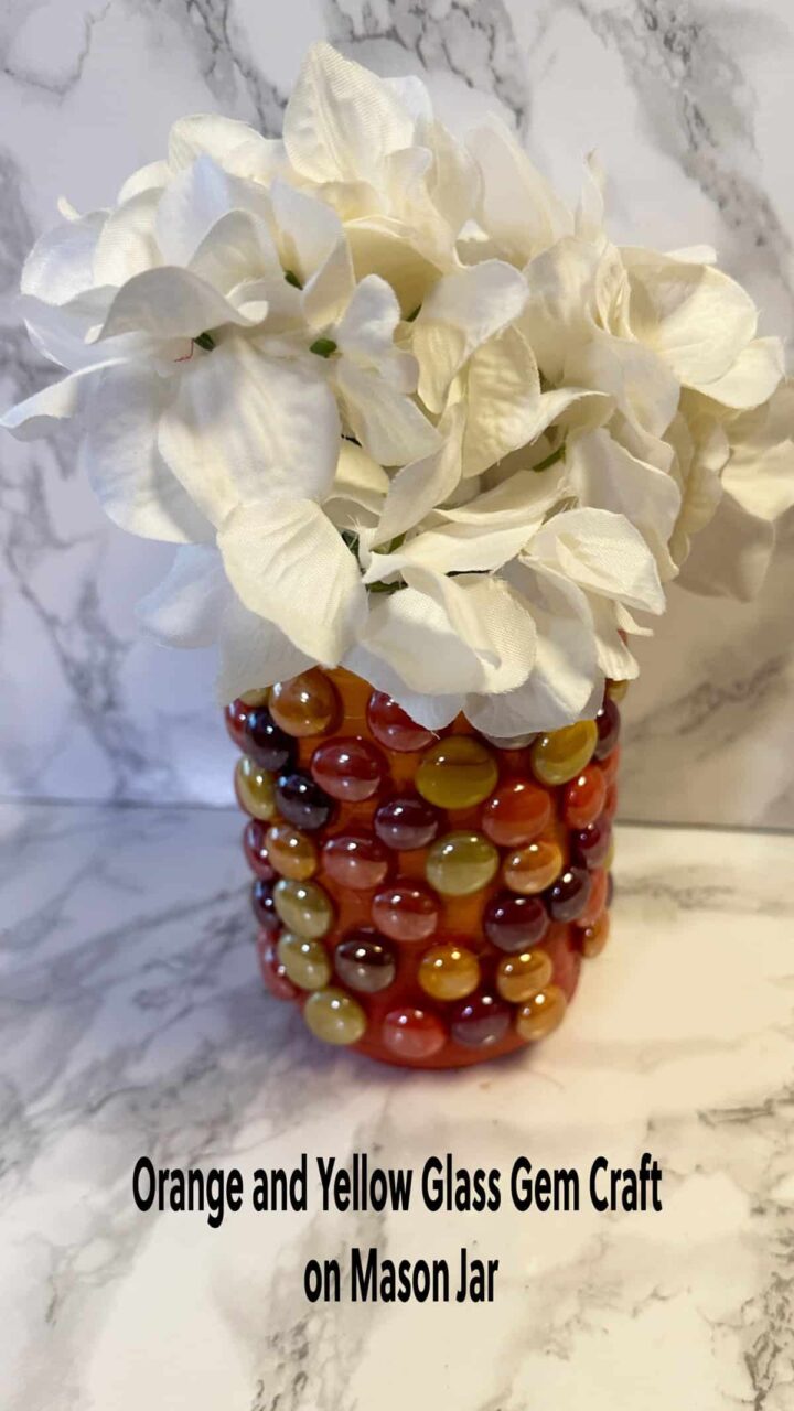 title and image mason jar with gems and paint and white faux flowers - size for pinterest