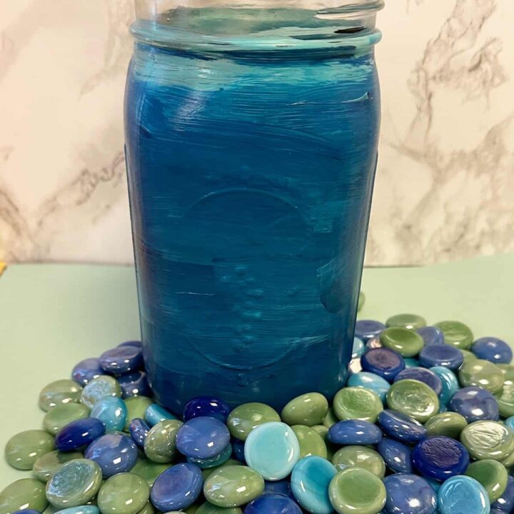 The finished painted jar with the gems below before gluing