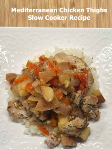 Title at the top and white plate with serving size of this Mediterranean Chicken Thighs Slow Cooker Recipe