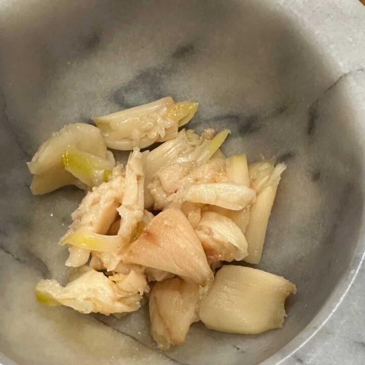 Roasted garlic cloves in a marble bowl