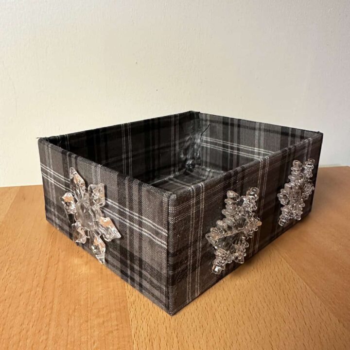 finished box on a brown table with a white wall