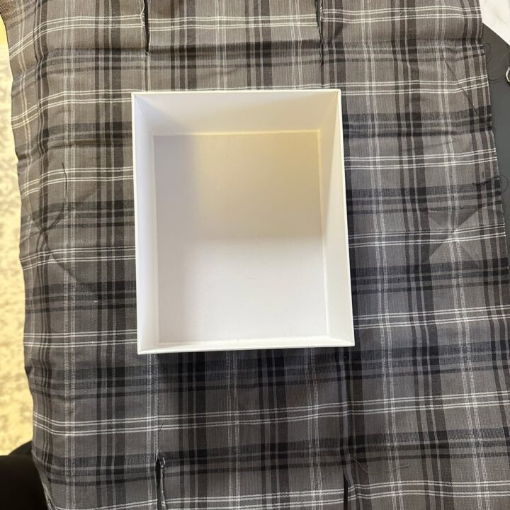 Lay the box on the fabric with the right side down