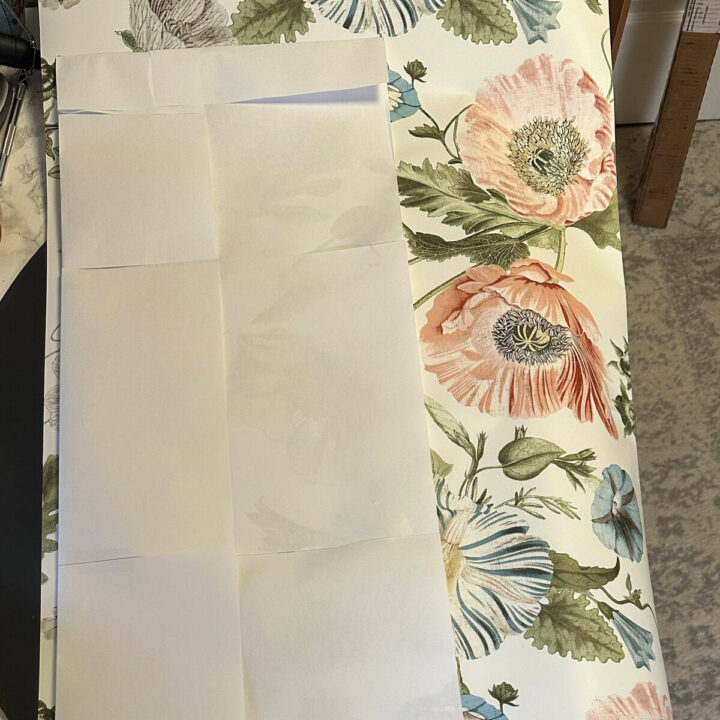 lay down the template on the wallpaper and cut around the design edges